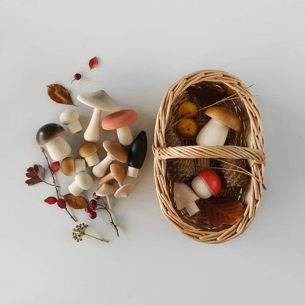 Set of toy wooden mushrooms with a wicker basket 