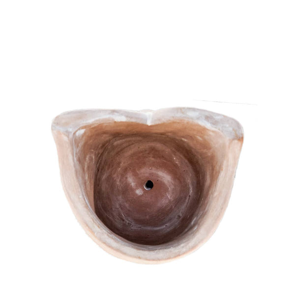Top view of owl-shaped planter with drainage hole