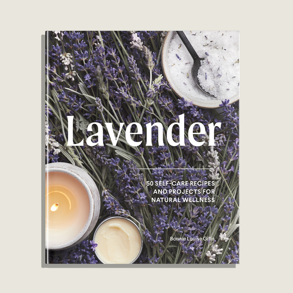 Book titled 'Lavender' with lavender flowers and candles on a light background
