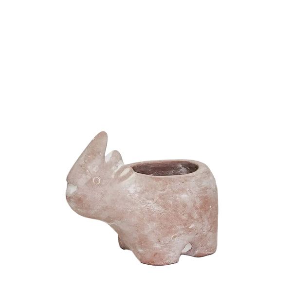 A small sculptural planter shaped like a rhinoceros, made from terracotta weathered finish, set against a plain off-white background.